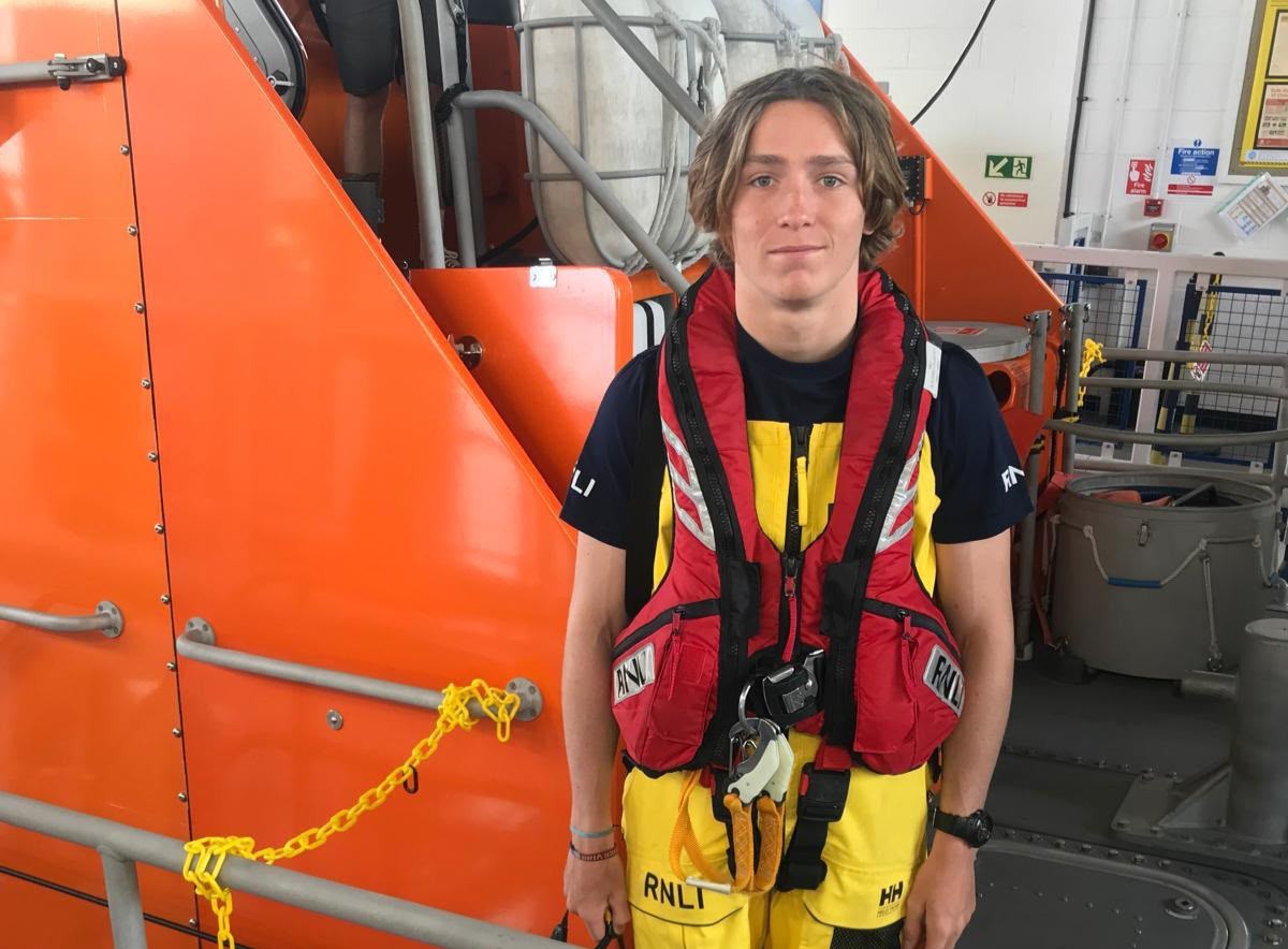 Eddie in crew kit stood in front of the all-weather lifeboat