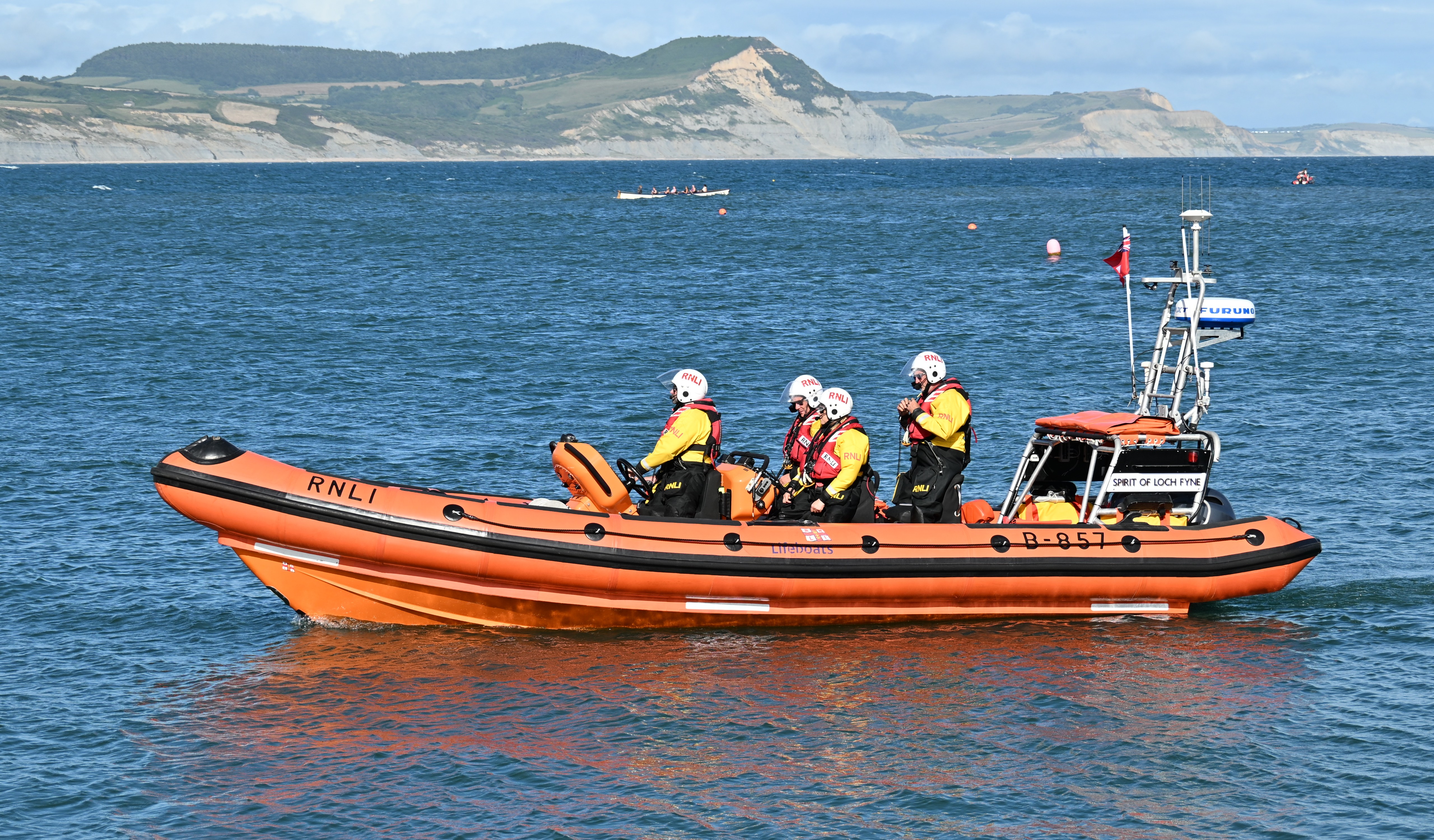 Orange lifeboat against blue sea