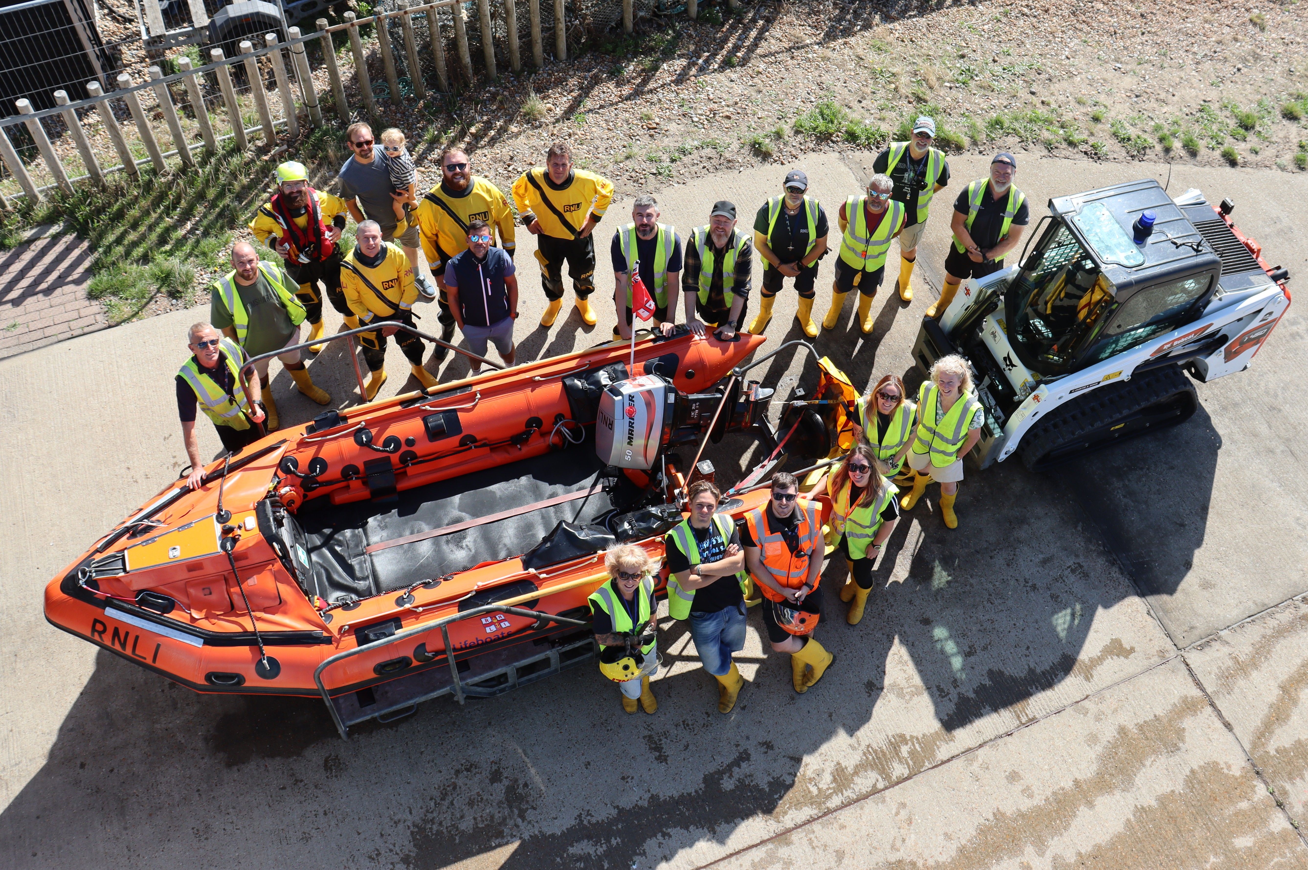 Group of RNLI volunteers around Hastings inshore lifeboat