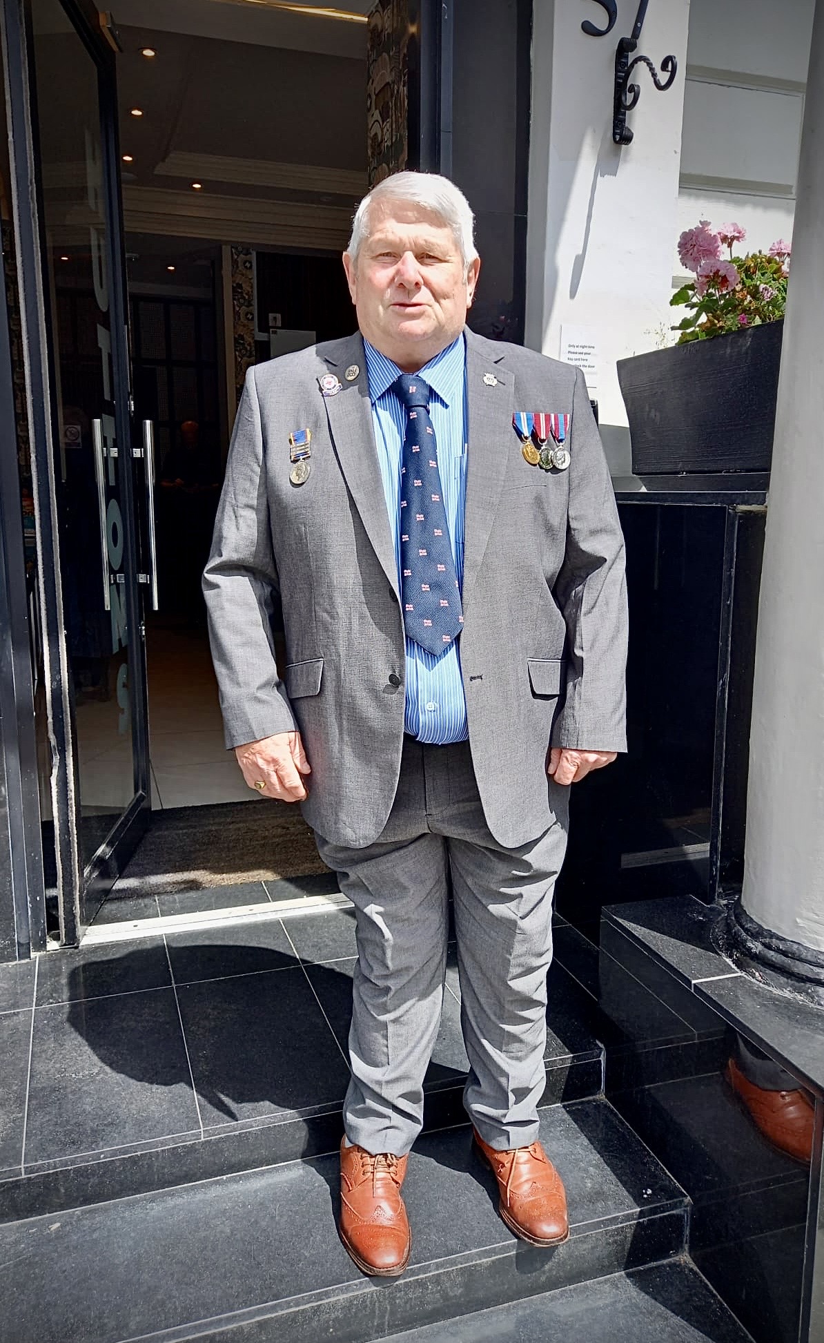 Captain David Freeman in a suit with medals on