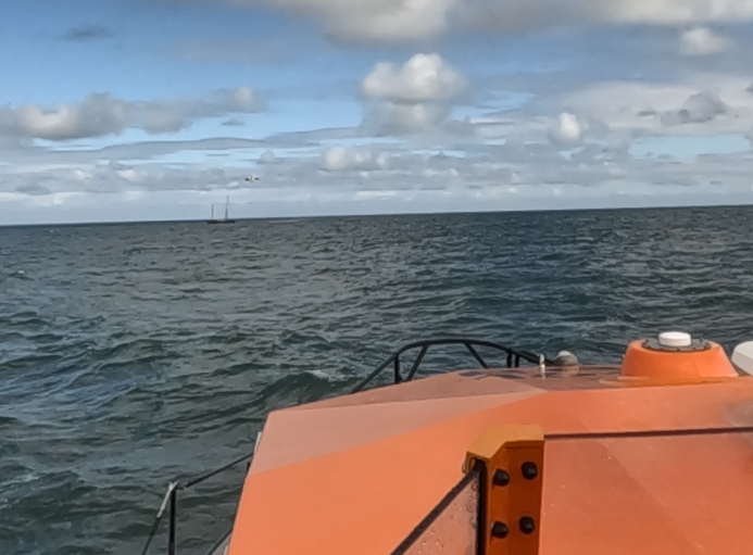 RNLI Moelfre All Weather Lifeboat approaching the scene.