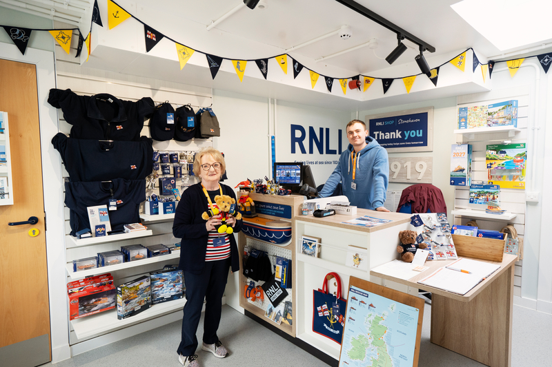 Inside of the new RNLI showing merchandise and shop volunteers