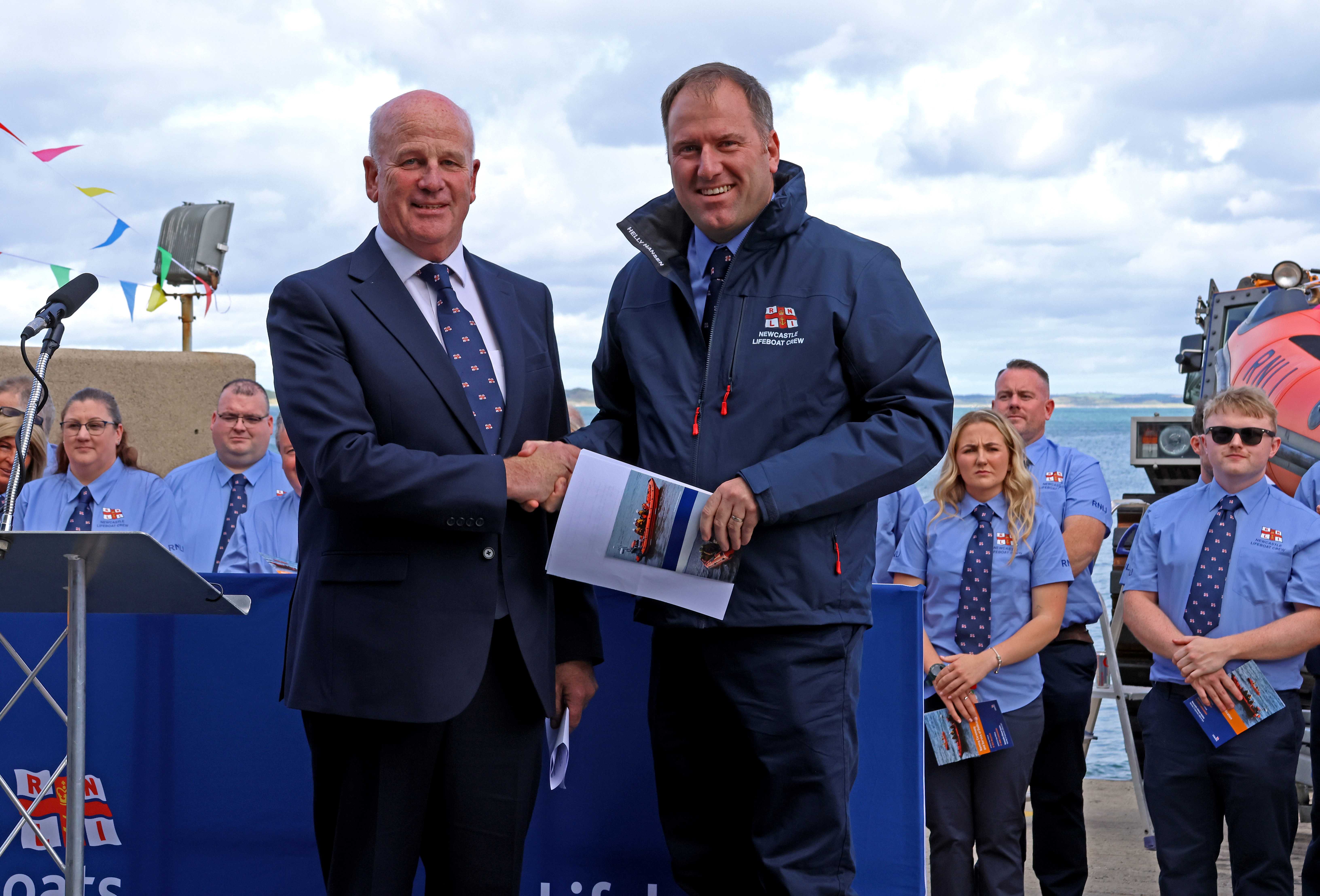 RNLI Trustee Paddy McLaughlin and Newcastle RNLI Launch Authority Daniel Curran shaking hands