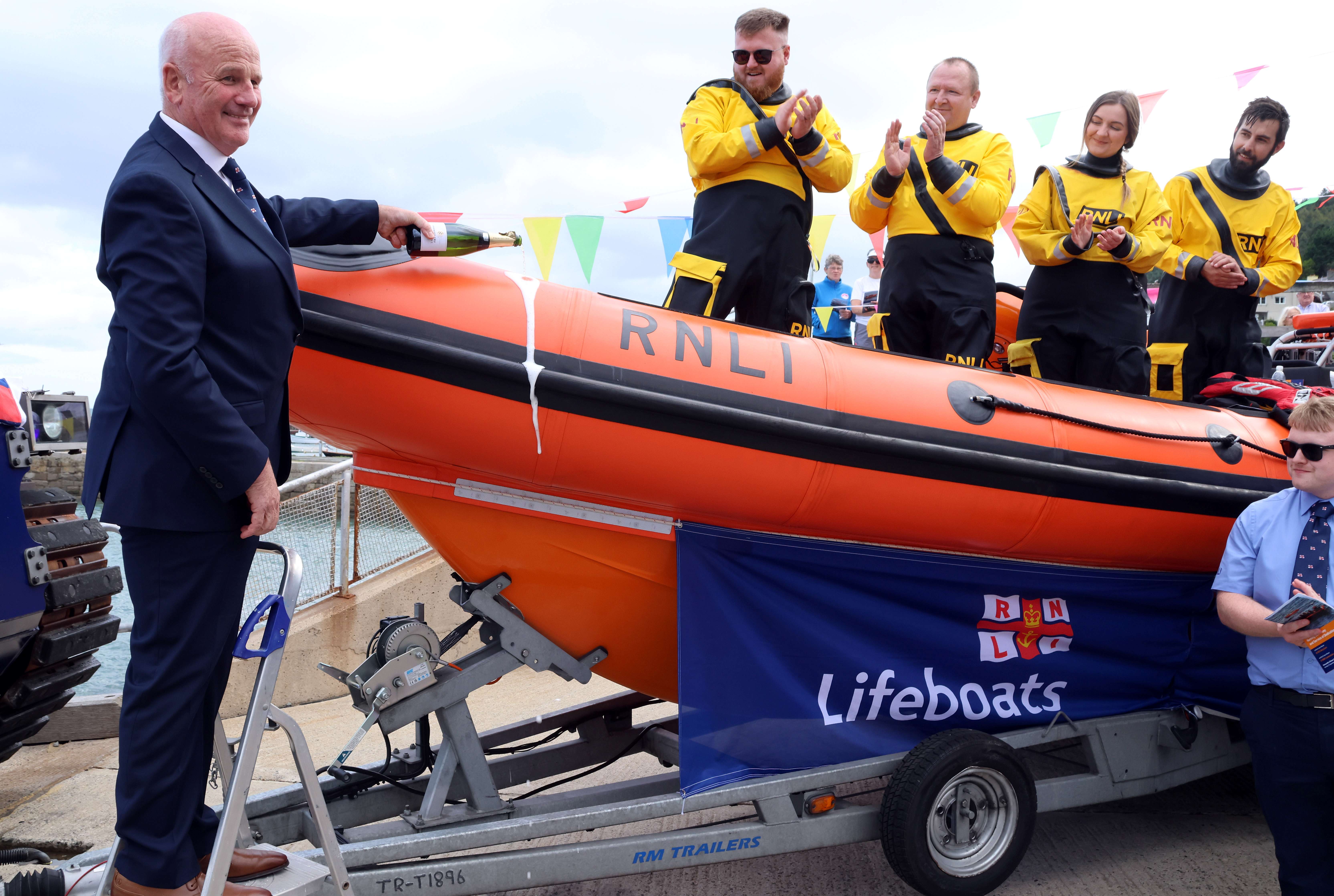 RNLI Trustee names the new Atlantic 85 class lifeboat, Berylium and pours over a bottle of champagne
