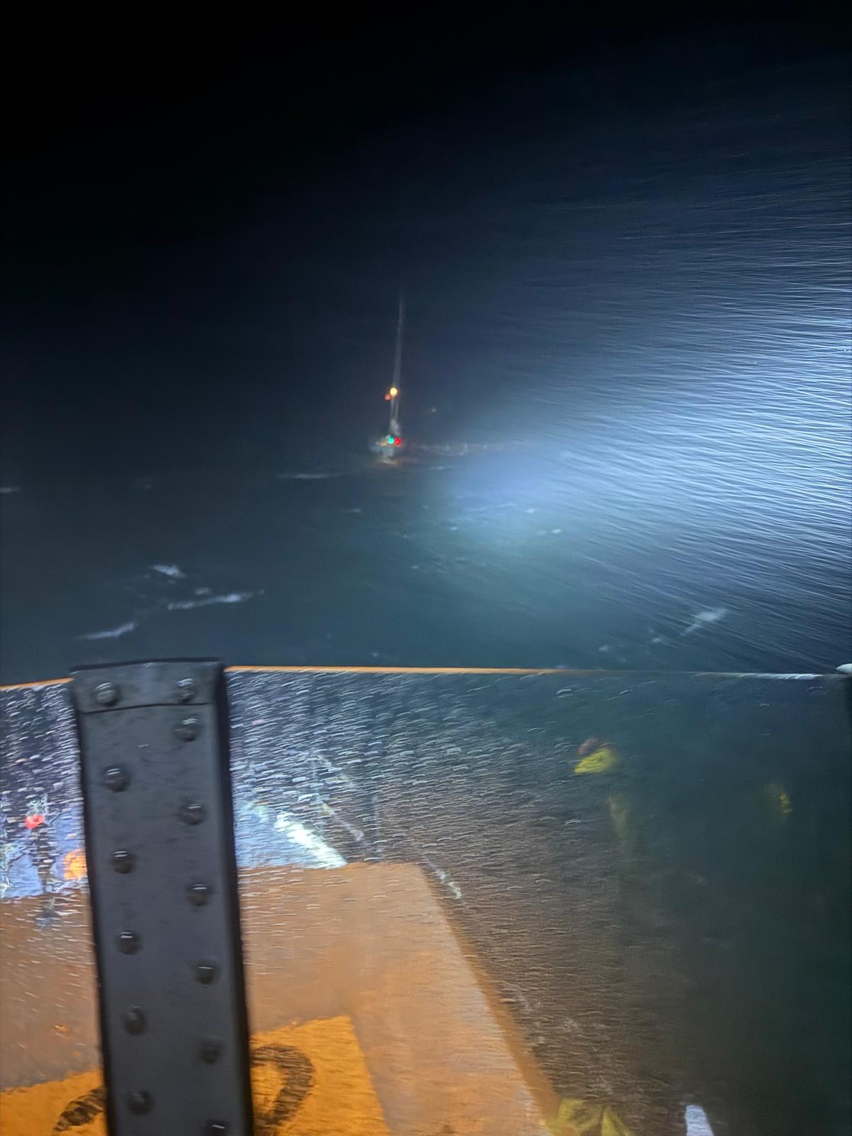 Red Bay RNLI's all-weather lifeboat at the scene on the water with the yacht in the distance