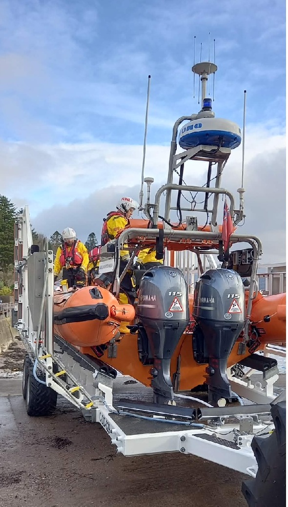 Crew on board the inshore lifeboat preparing for launch