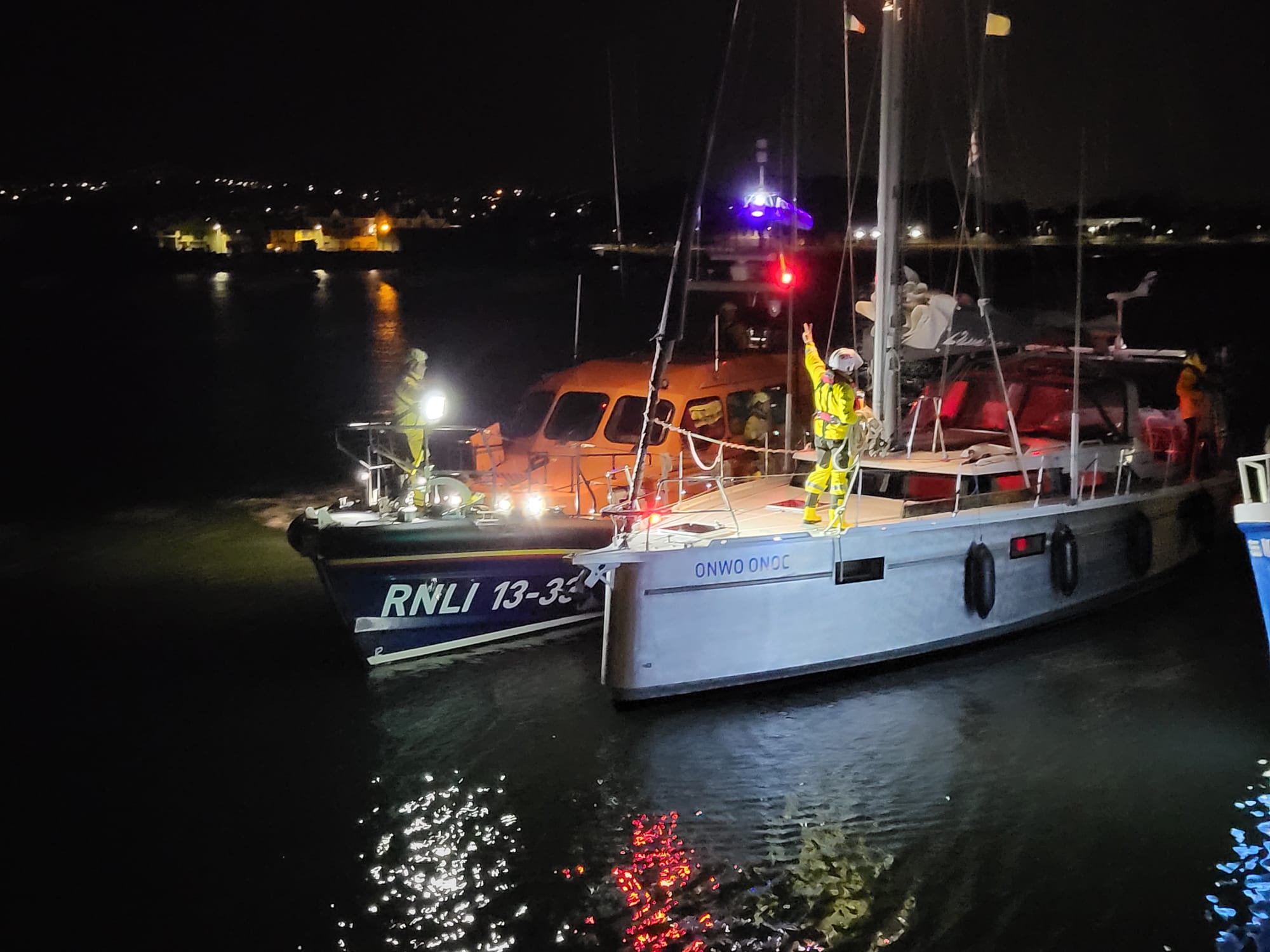 Wicklow lifeboat with a 40 foot yacht in an alongside tow, in Wicklow Harbour