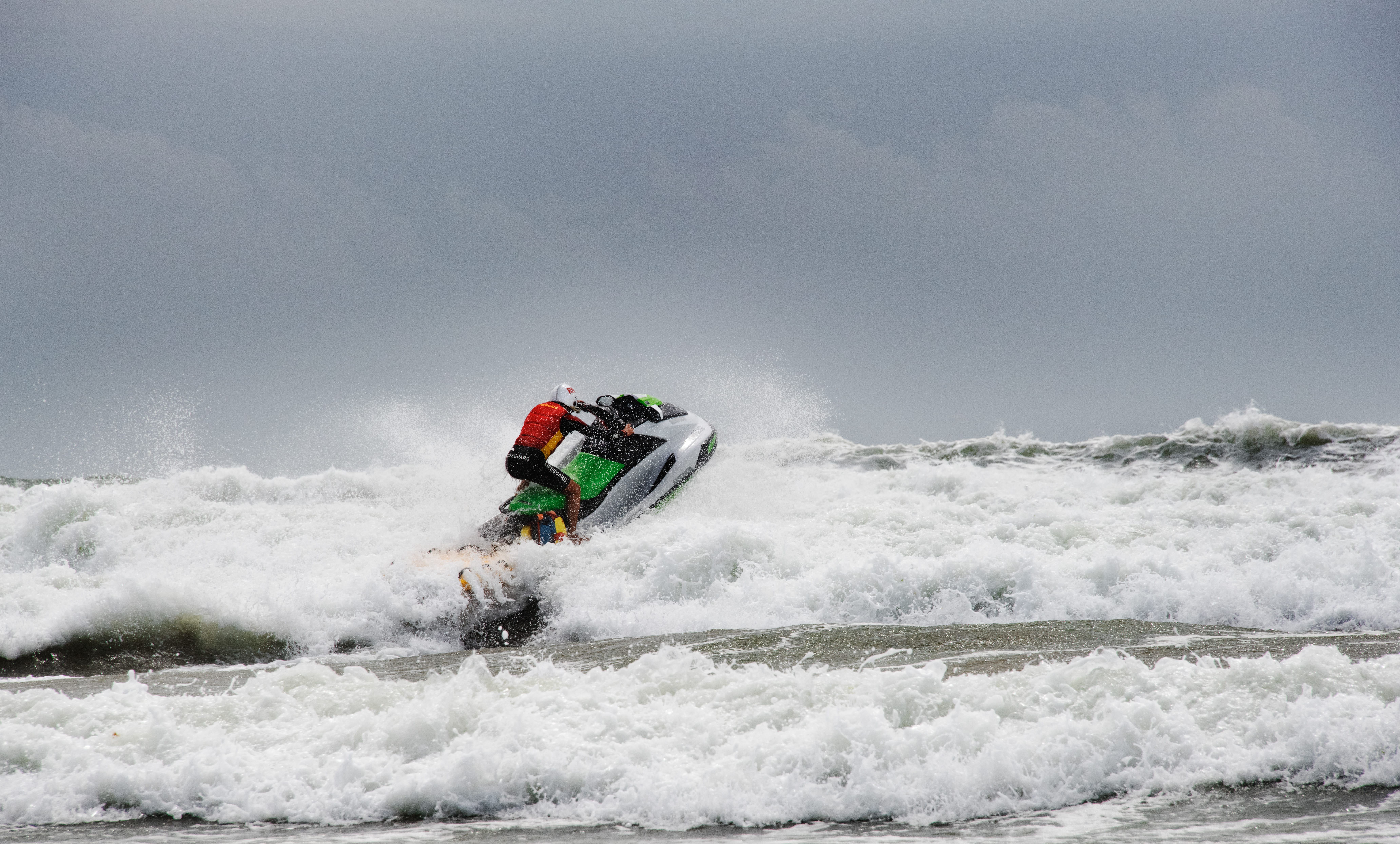 Stock image of RNLI lifeguard on RWC in surf