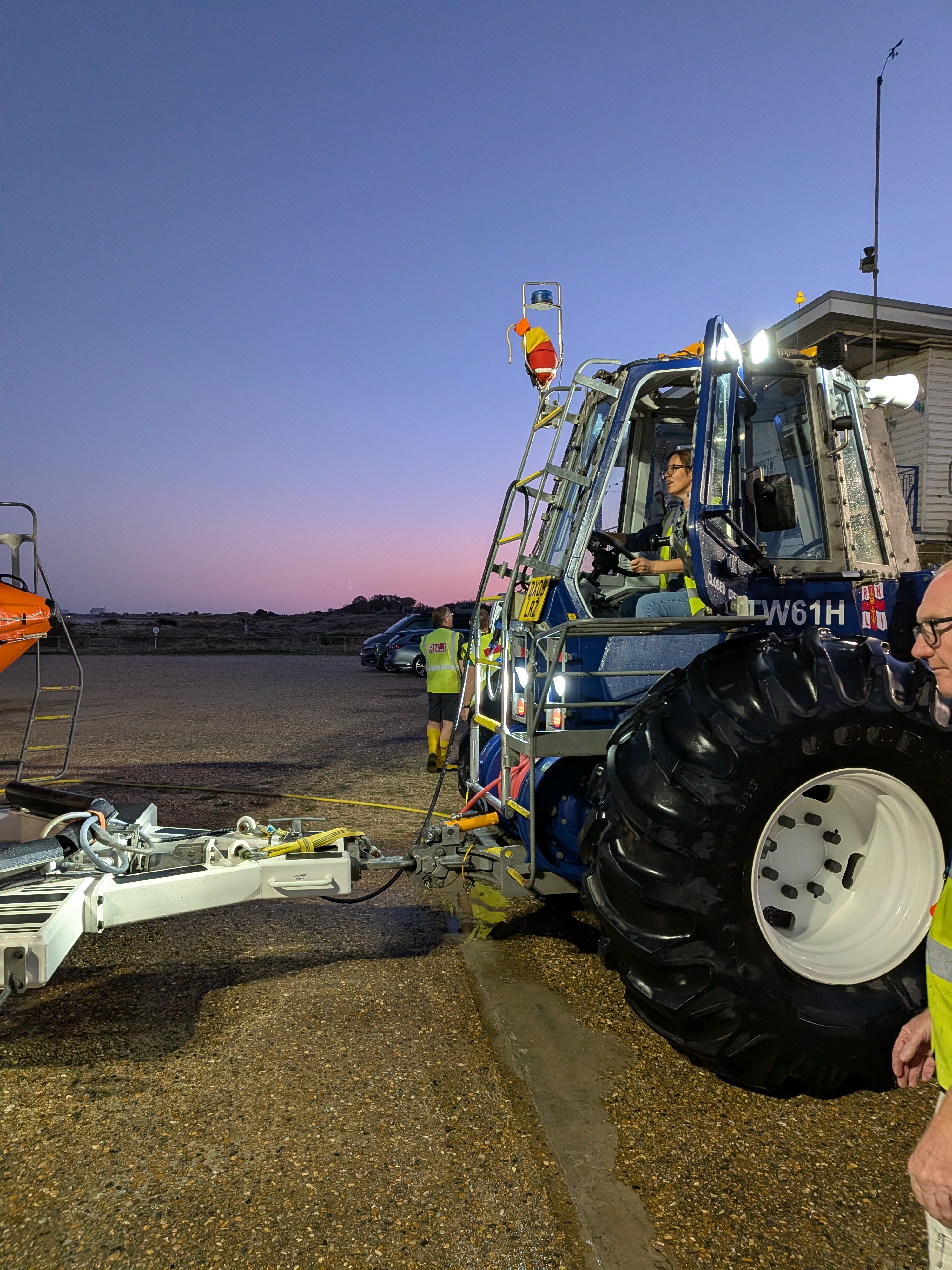Selina is driving a large blue Talus Bendy tractor as part of her training 