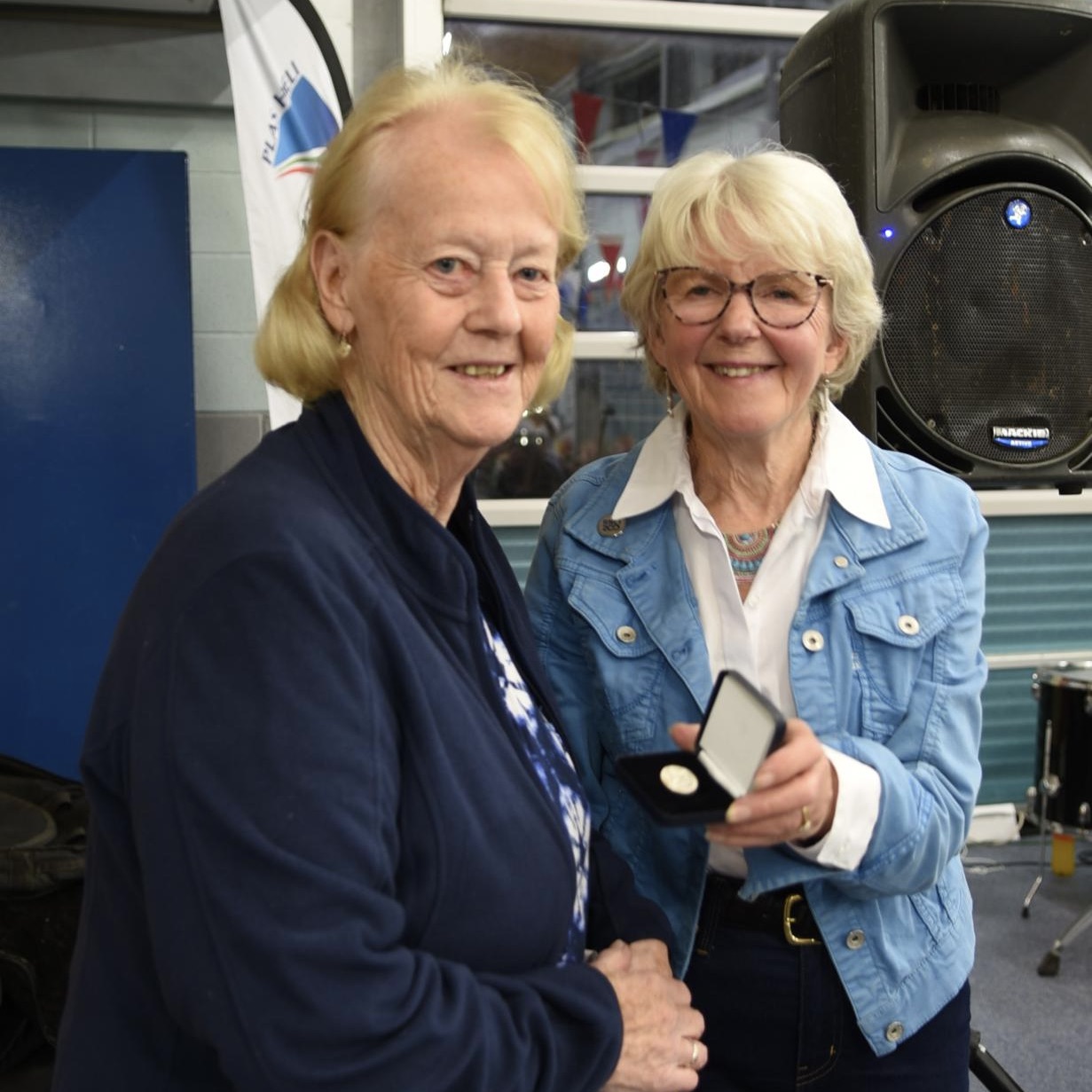 Alison Hayes, Chair of Pwllheli RNLI Fundraising Team presenting medal to Sue Carlton