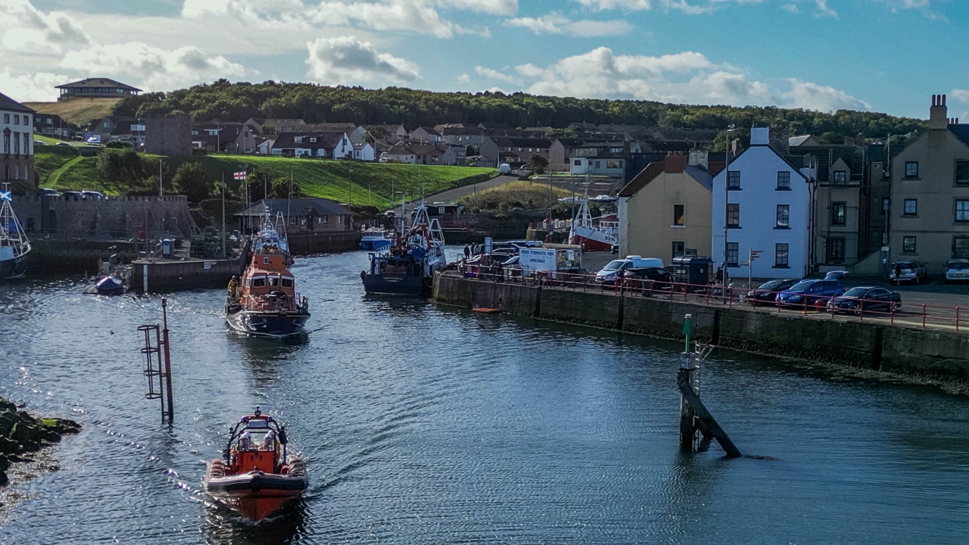 Two lifeboats in harbour.