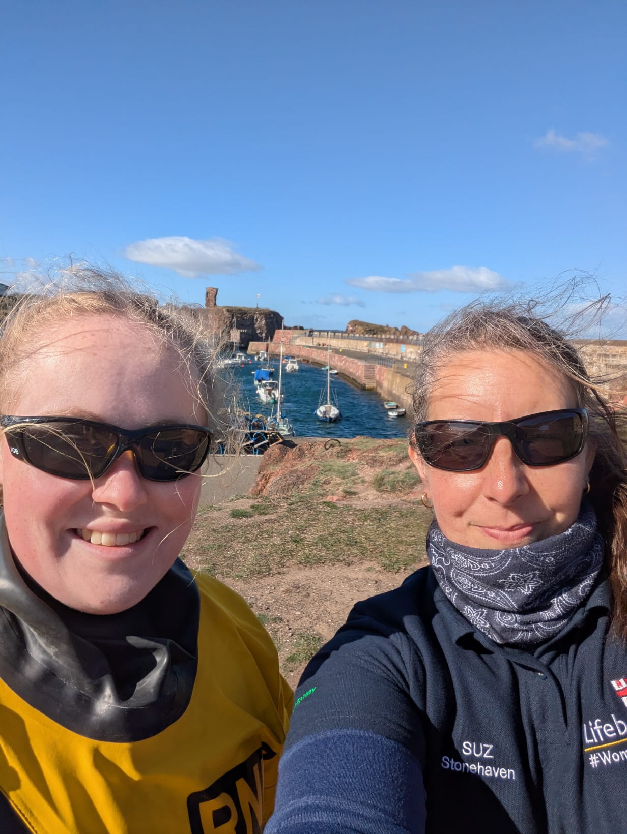 Image of boat crew volunteer in dry suit and shore crew volunteer in RNLI kit