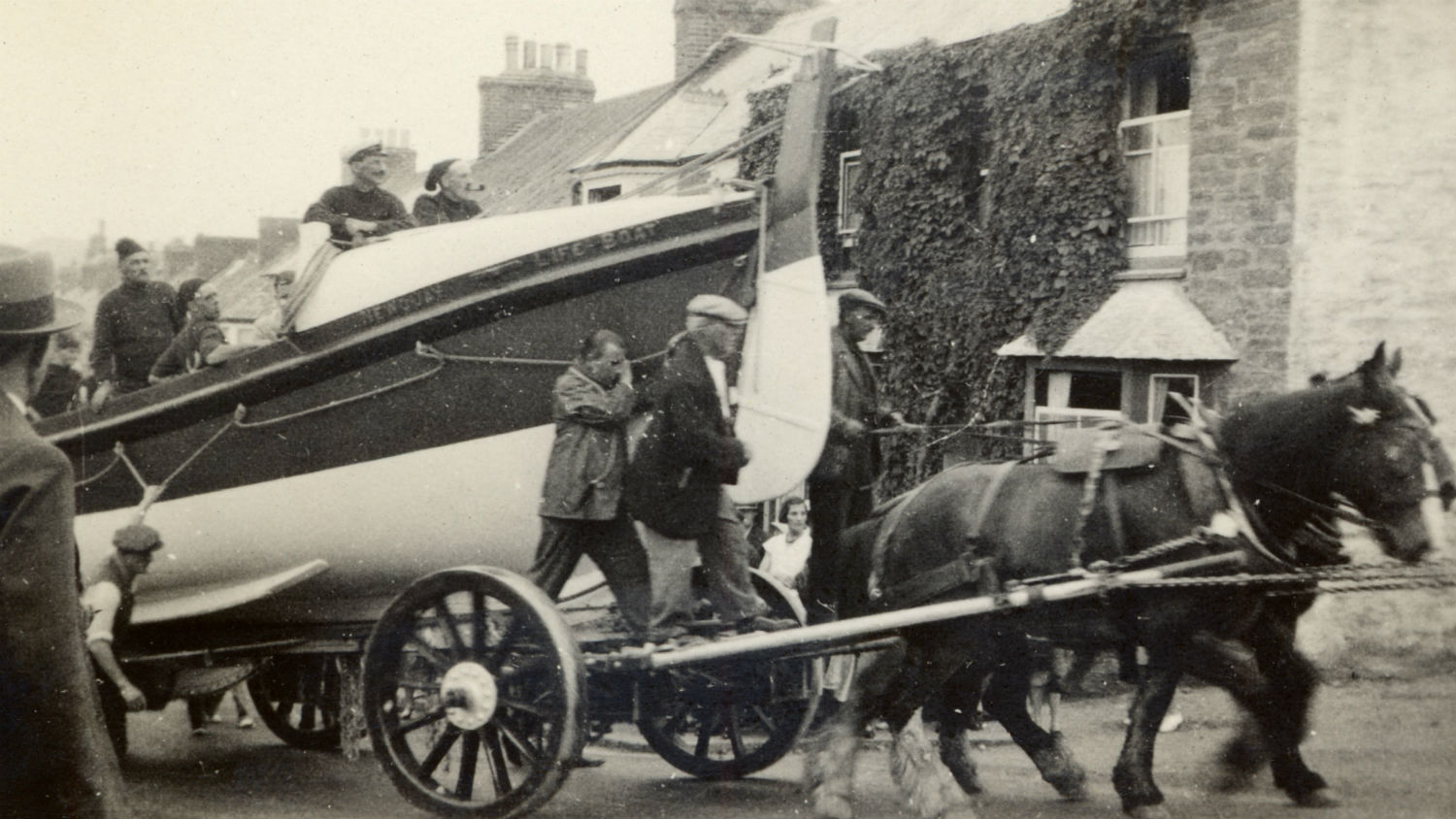 1933: Newquay’s self-righting class lifeboat Admiral Sir George Back on a carriage with five crew onboard being towed by horses