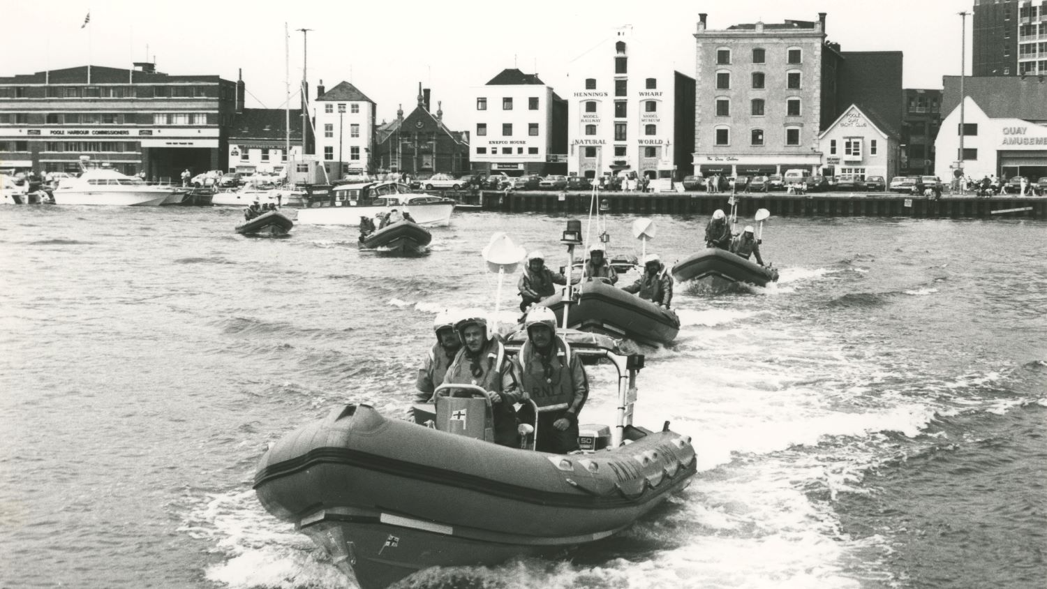 Black and white image of five inshore lifeboats