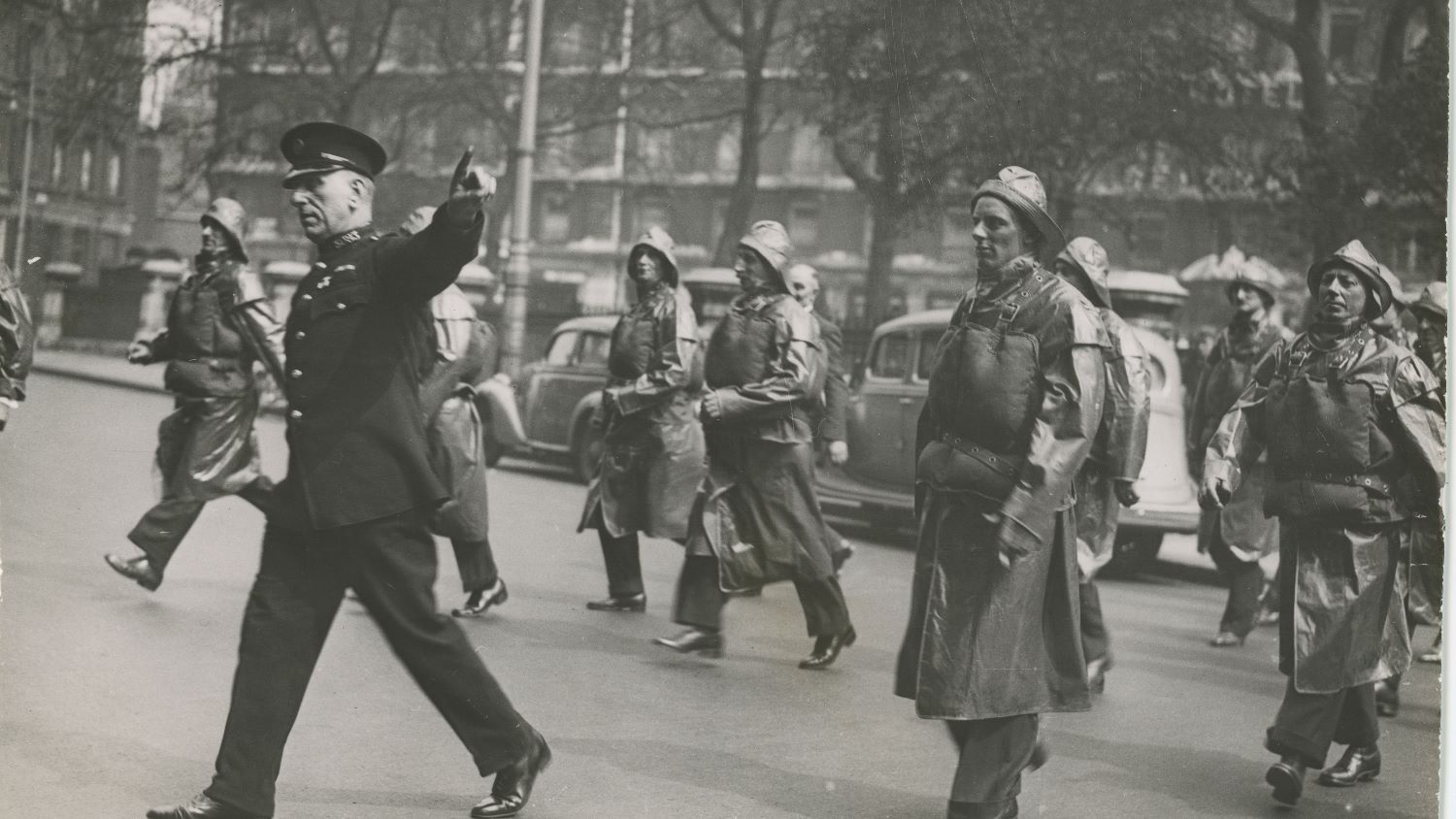 Black and white image of lifeboat crew crossing road in London