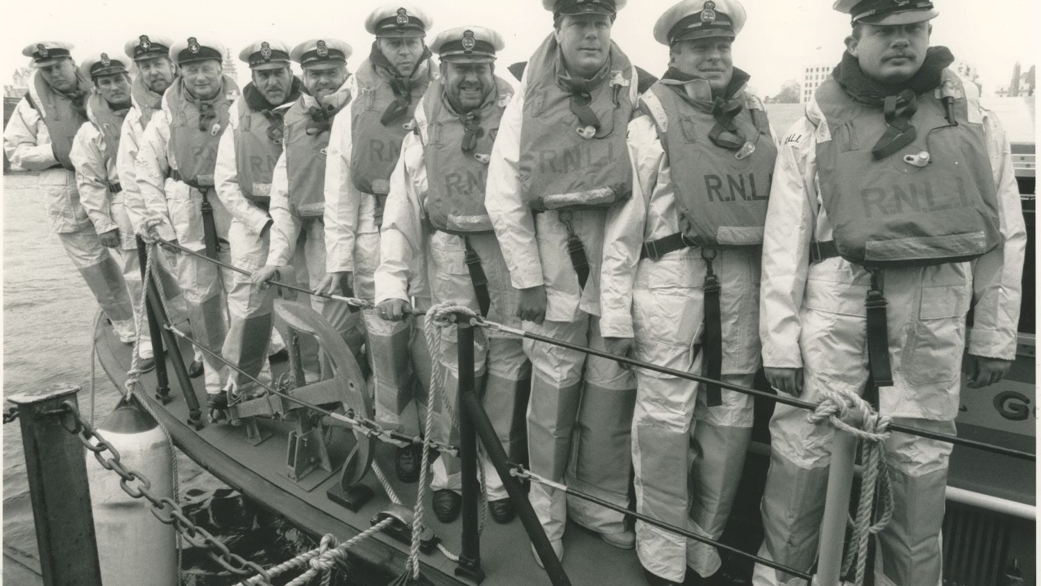 Black and white image of eleven crew onboard lifeboat