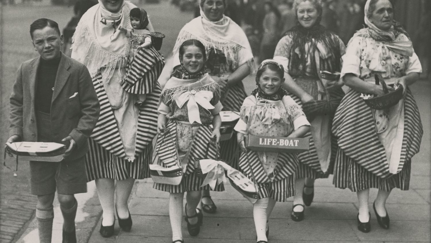 Black and white image of group of women and children collecting for the RNLI