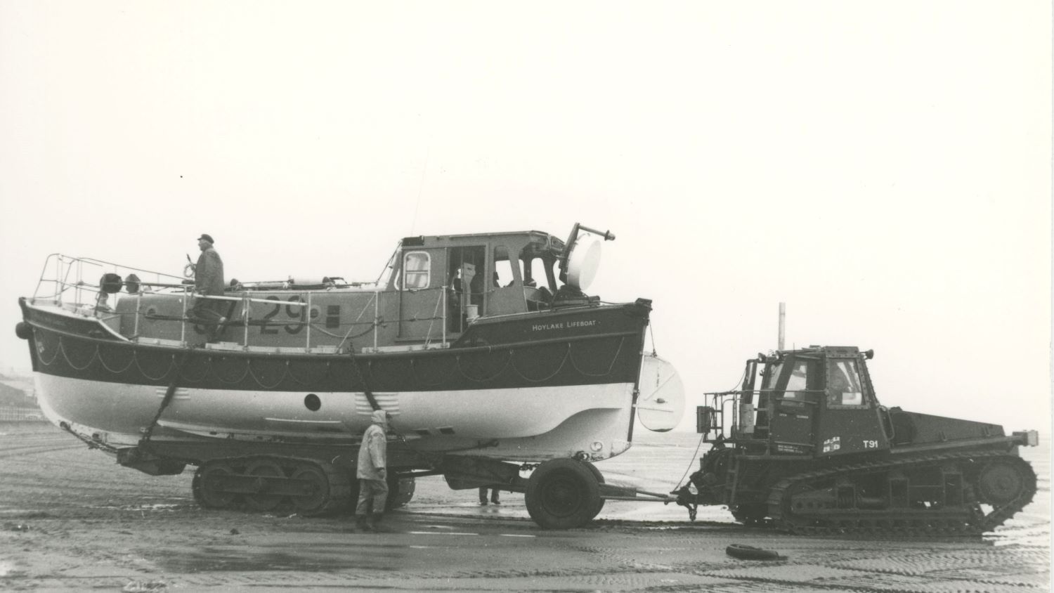 Black and white image of tractor towing Hoylake lifeboat