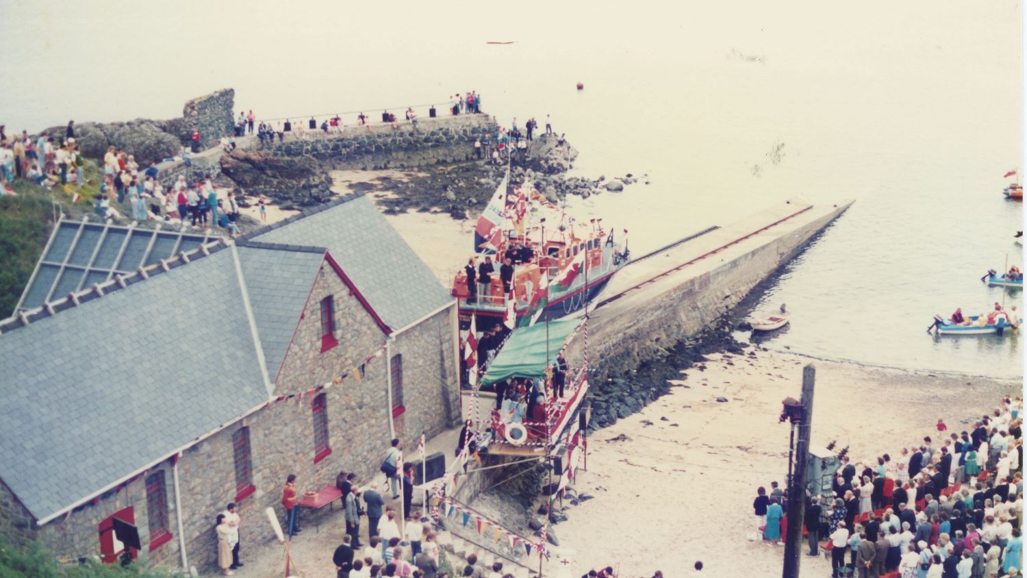 Colour image of lifeboat on slipway with naming ceremony audience alongside