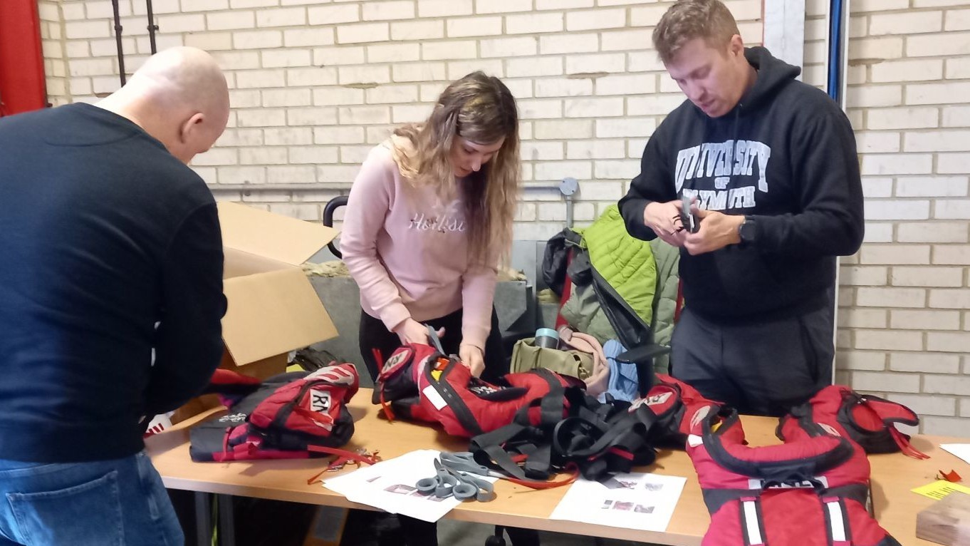 Preparing red lifejackets for upcycling