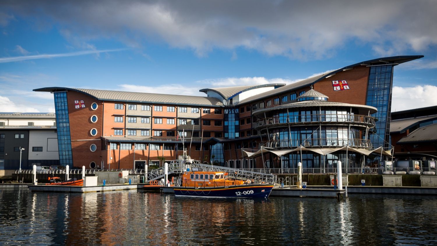 Landscape shot of the RNLI College in Poole taken from Holes Bay