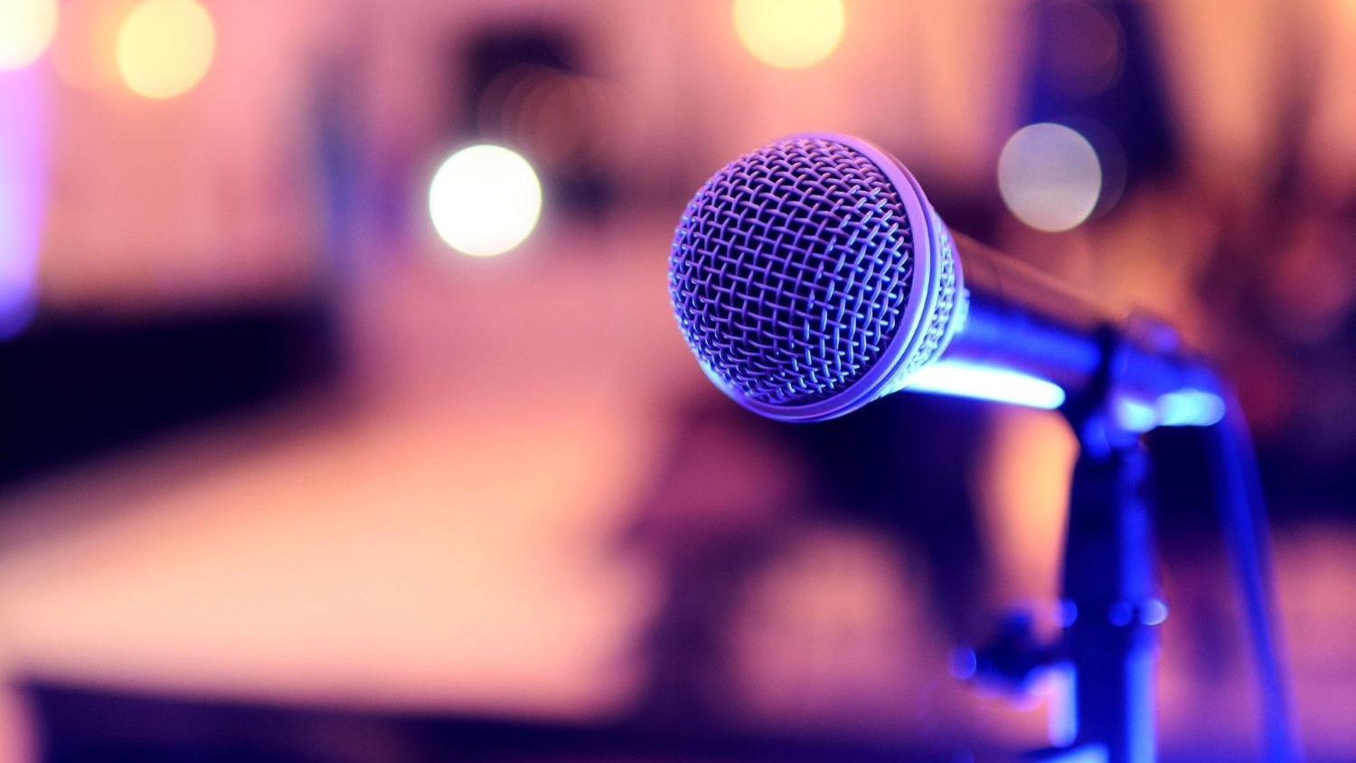 Microphone on a stand with out of focus lights in the background