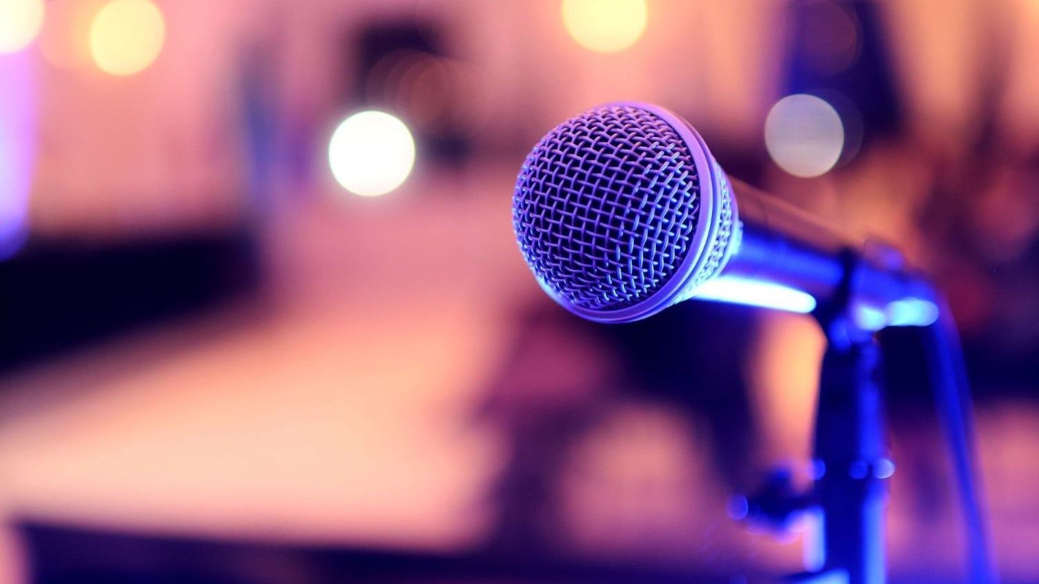Microphone on a stand with out of focus lights in the background