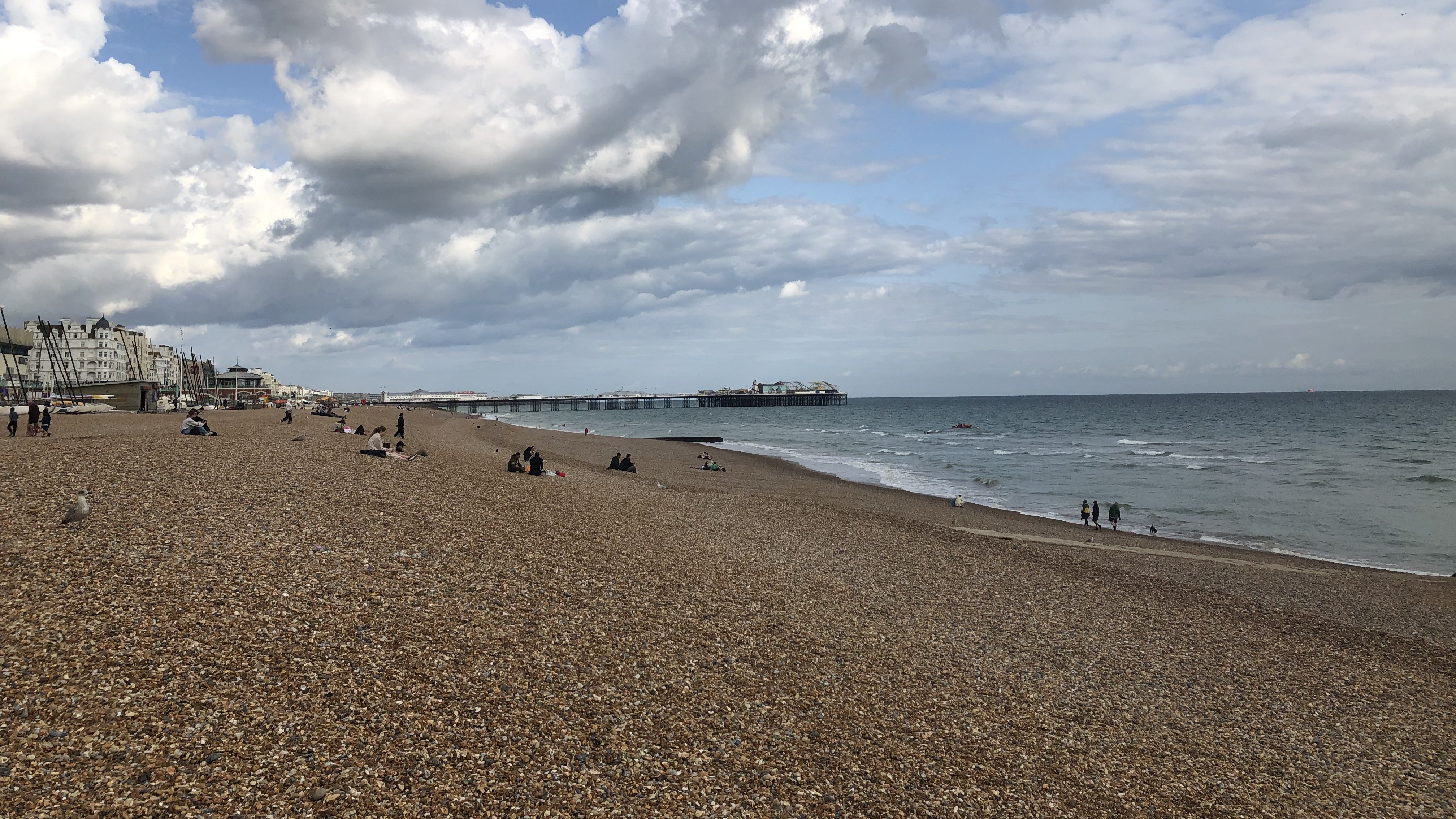 Image shows the pebbled West Pier beach on an overcast day