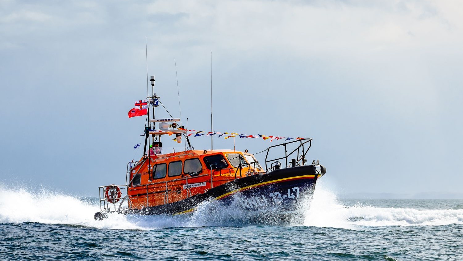 A Shannon class all weather lifeboat decorated with flag bunting.