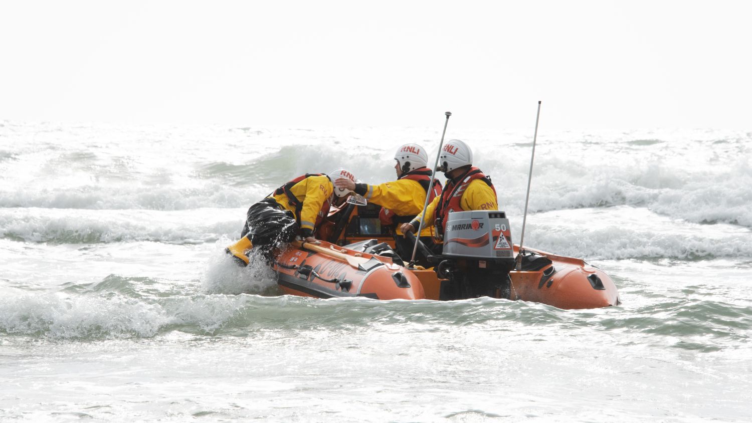 Barmouth D-class inshore lifeboat Craig Steadman D-814 being launched in choppy water.