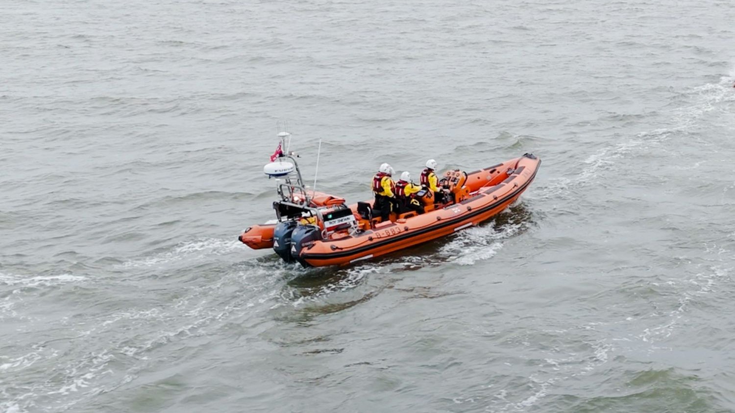 A large rib with three crew on board.
