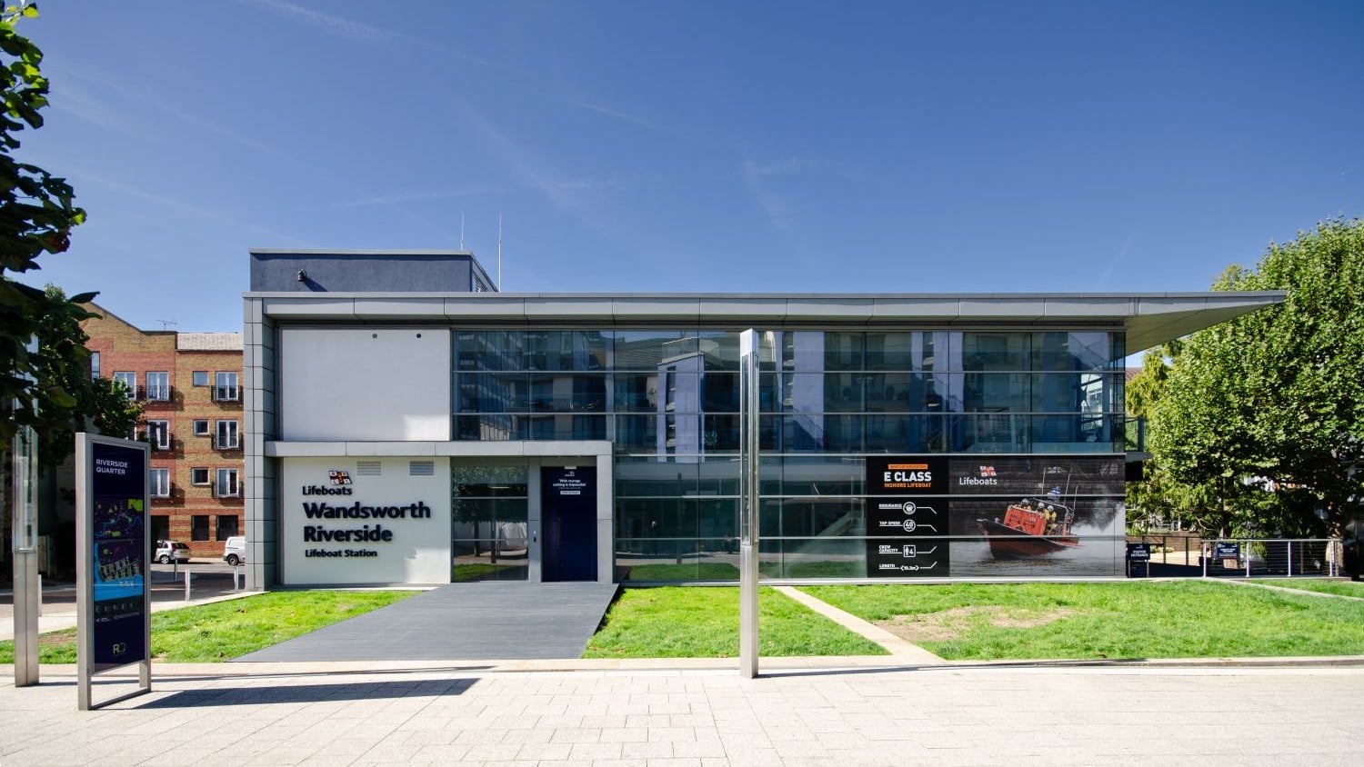 A two-storey glass building with a grey roof.