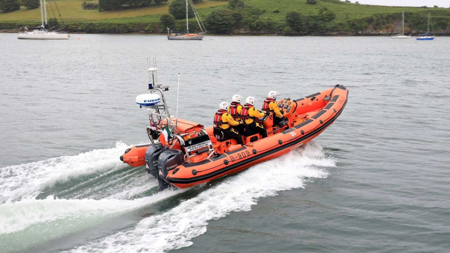 The Kinsale lifeboat speeding over calm water.