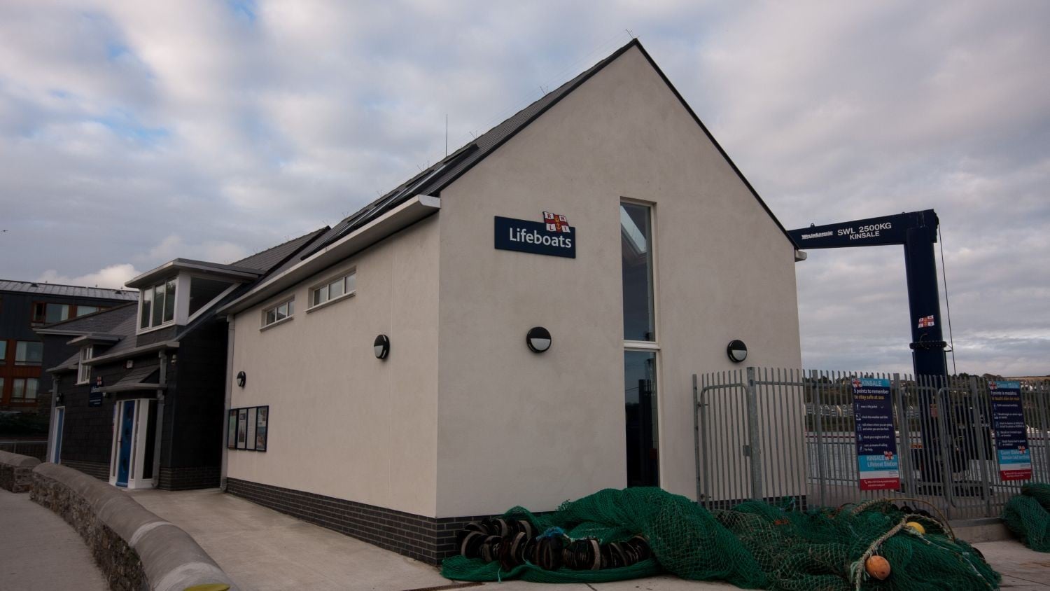 A grey building with a pointy roof.