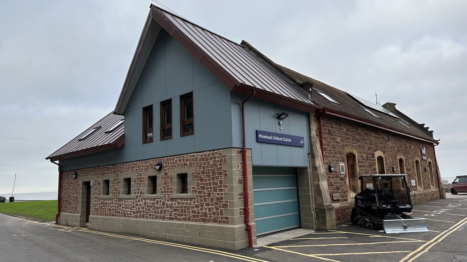 A red brick and blue building with a pointy roof.