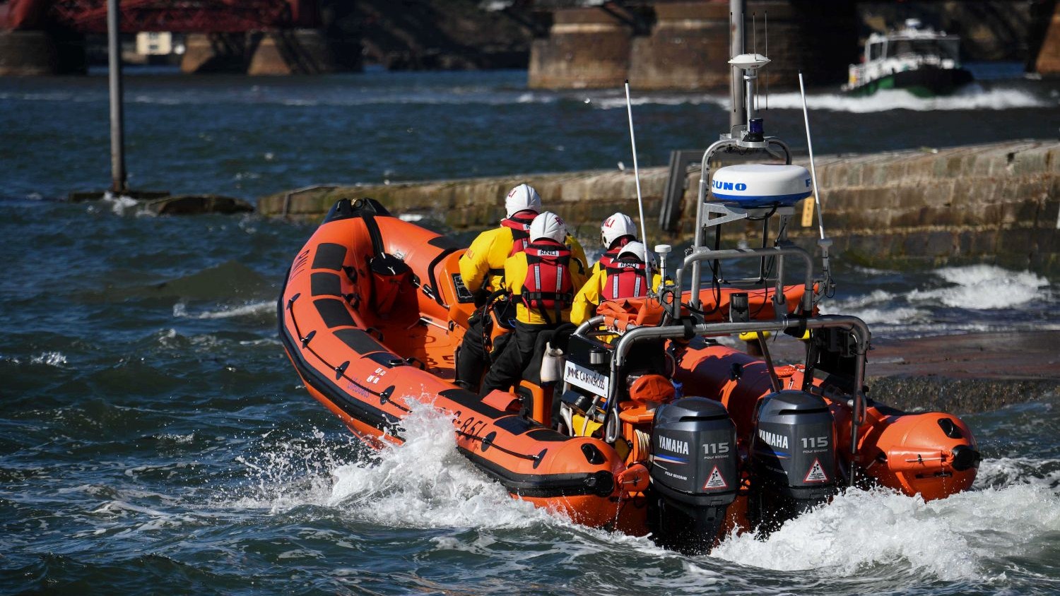 The Queensferry RIB lifeboat in choppy waves on a sunny day.