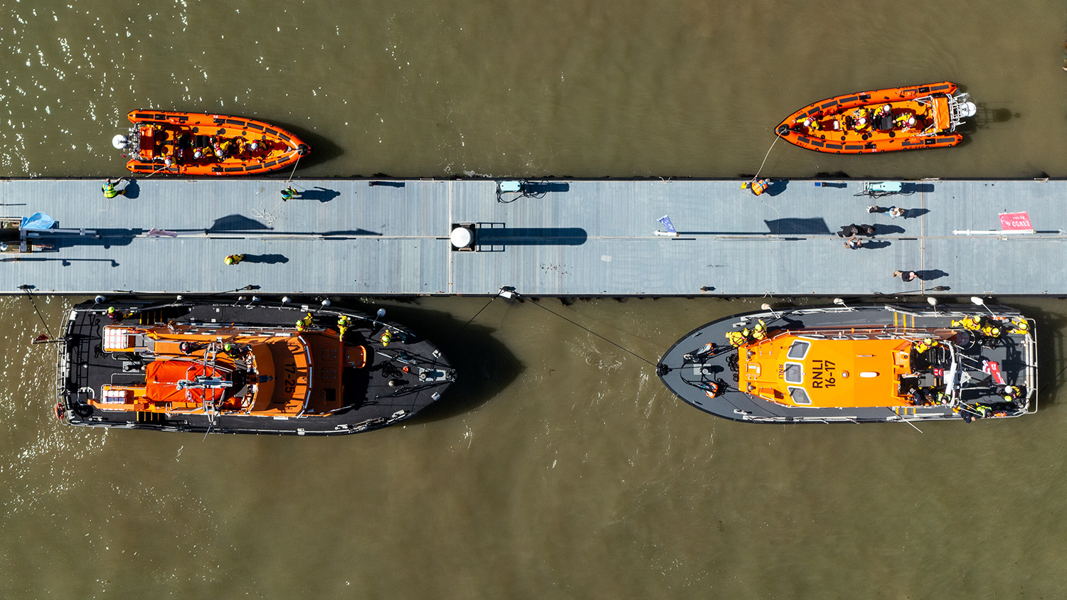 An aerial photograph showing two Atlantic 85 lifeboats, moored opposite a Tamar and a Severn class lifeboat. 