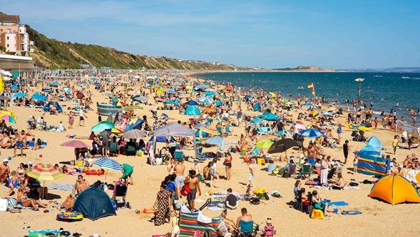 Photo of a busy beach in Boscombe during the summer lifeguard season. 
