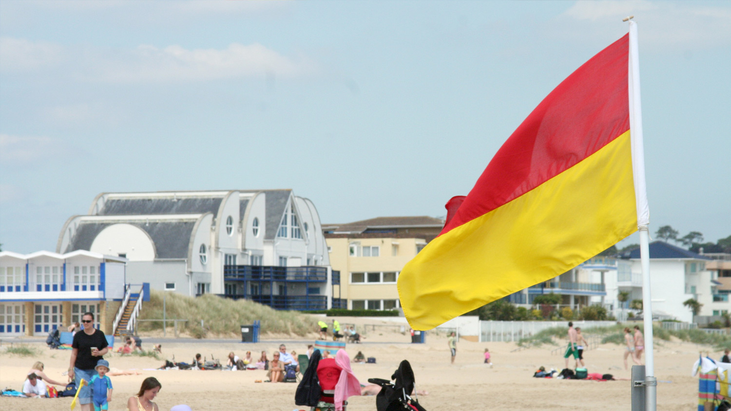 A red and yellow flag on Sandbanks Beach
