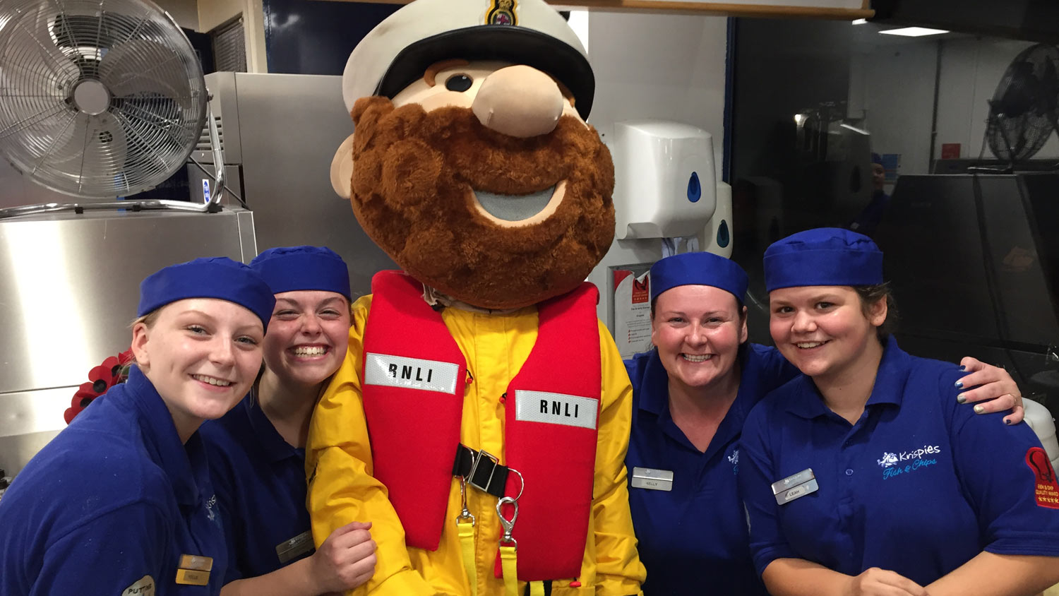 RNLI mascot Stormy Stan and the staff at Krispies chip shop, Exmouth
