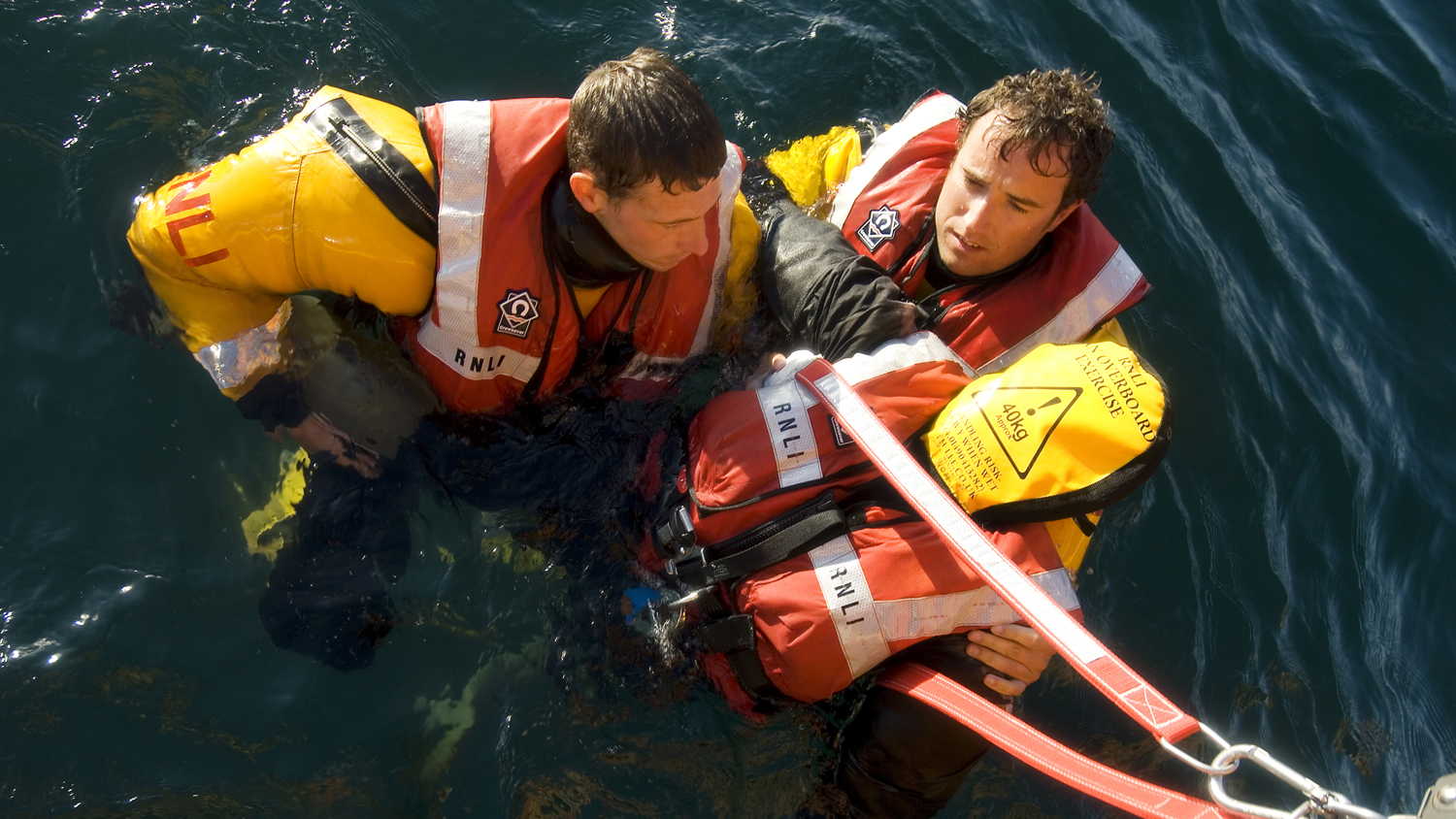 RNLI crew members training with their manikin, Dead Fred