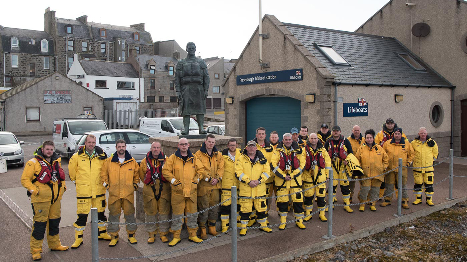 Fraserburgh lifeboat crew next to the memorial