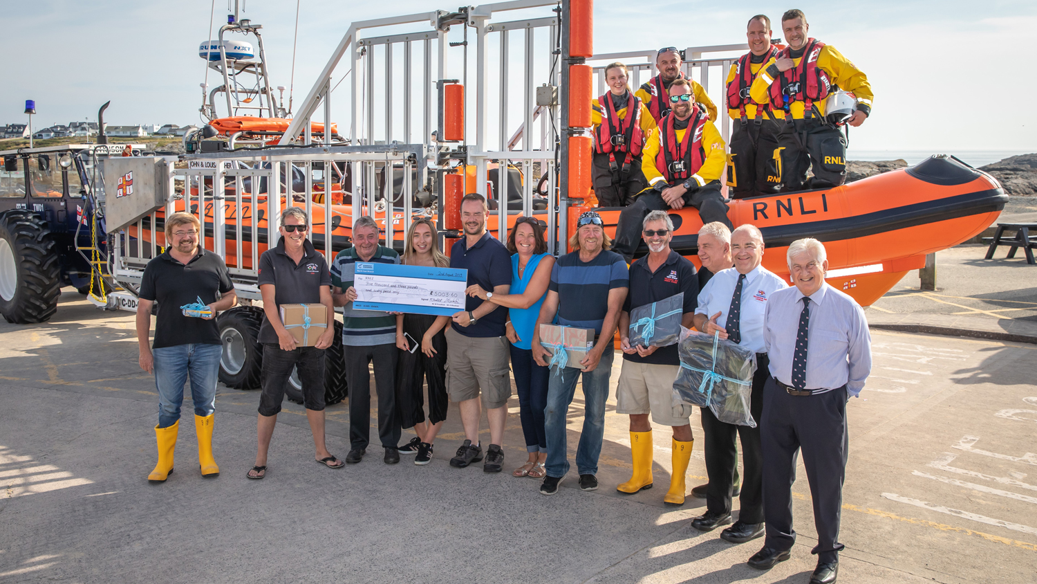 Megan, Julie, Malcolm and Anthony present the cheque to Trearddur Bay RNLI volunteers
