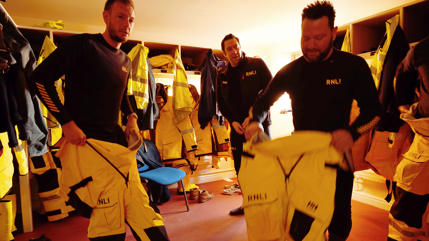 Skegness crew members change into their all-weather lifeboat kit before heading to the lifeboat
