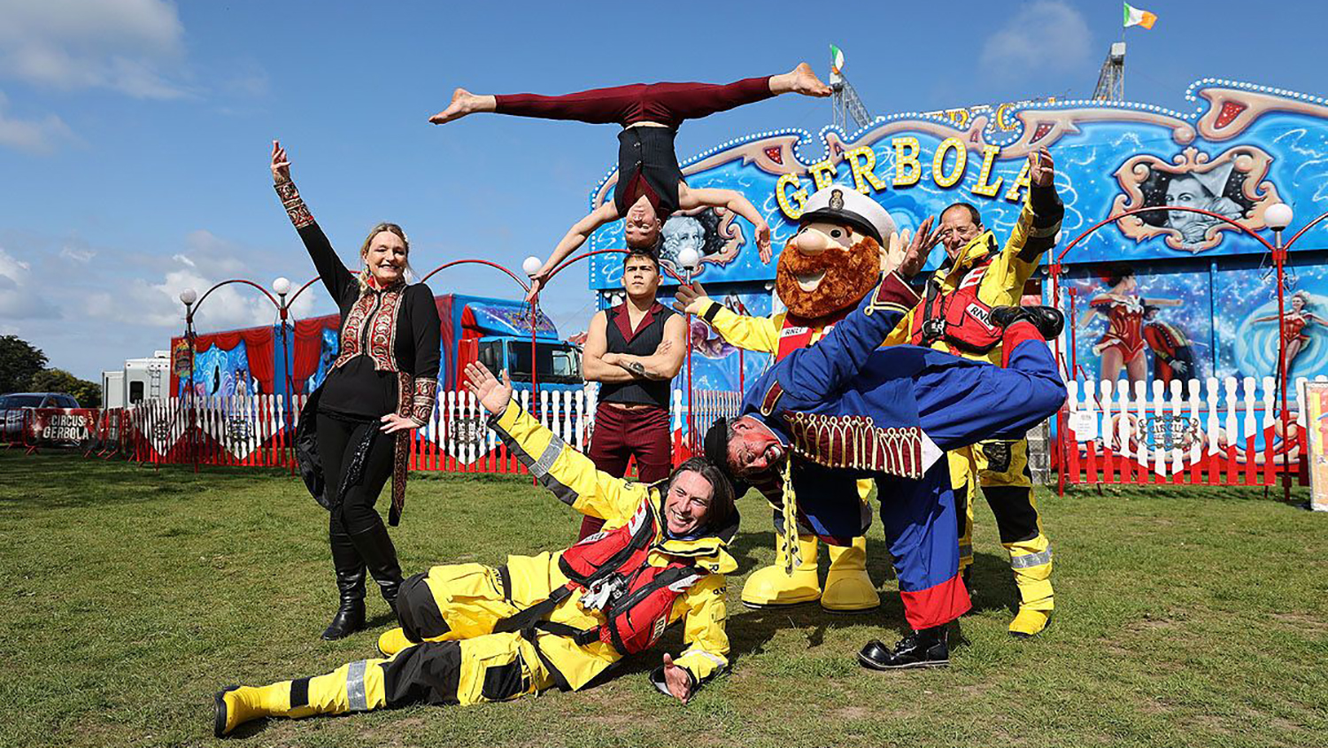 Howth RNLI crew in kit join members of Circus Geobola in striking an acrobatic pose 