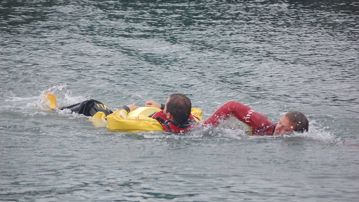 David the lifeguard rescues a crew member from the water in a demonstration for Poole Lifeboat Station's open day