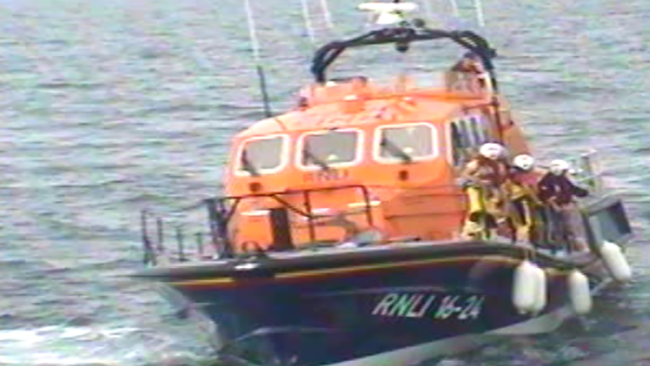 The crew lined up on the deck of the Tamar class lifeboat, ready to pull in the casualties from the water