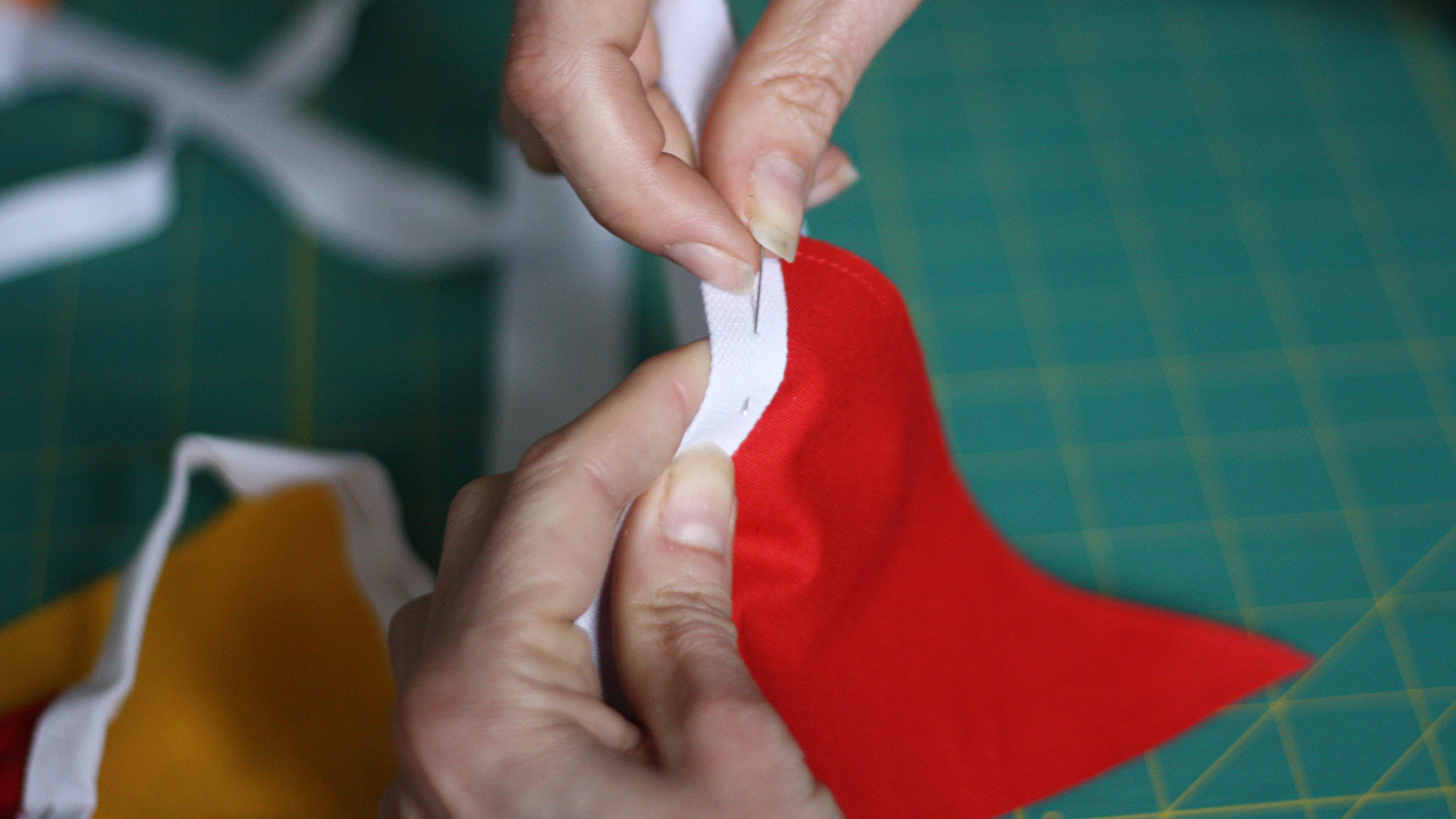 Sew through both sides of the tape and along the top of each flag