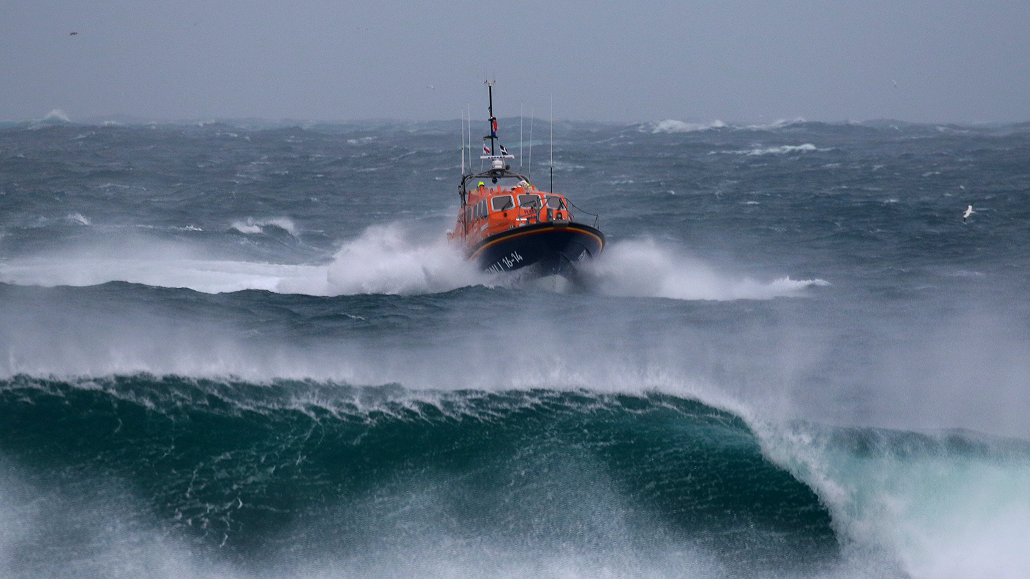 Tamar class lifeboat City of London III ploughs through crashing waves on the way back to Sennen Cove