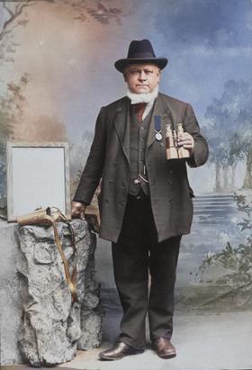Vintage photo of Blackrock RNLI Coxswain Bernard Hamilton posing with binoculars